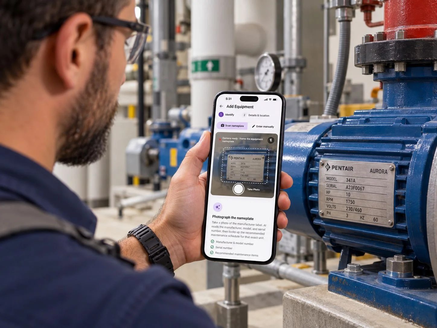 Maintenance professional using TapHero on a phone to scan the nameplate on a building pump in a mechanical room.